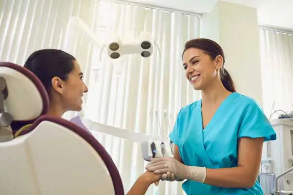 Smiling dentist talking to her female patient about dental implants at Grins & Giggles Family Dentistry in Spokane Valley, WA