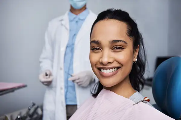 Smiling dental patient sitting in exam chair during wisdom teeth consultation at Grins & Giggles Family Dentistry in Spokane Valley, WA