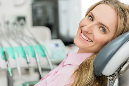 Young woman smiling in dental chair at wisdom teeth consultation at Grins and Giggles Family Dentistry in Spokane Valley, WA
