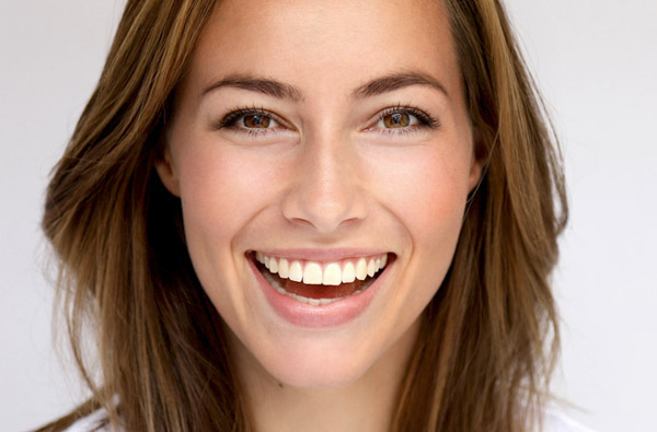 Beautiful woman smiling after cosmetic dental treatment at Grins & Giggles Family Dentistry in Spokane Valley, WA