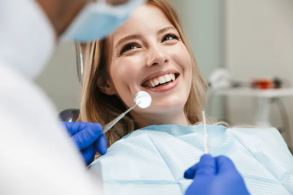 Patient happily waiting in a dental chair for her dentist to begin her routine dental exam at Grins & Giggles Family Dentistry in Spokane Valley, WA