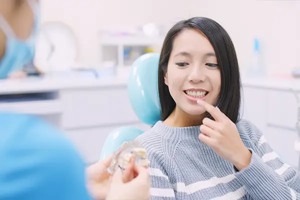 Doctor explaining the dental implant process to a patient at Grins & Giggles Family Dentistry in Spokane Valley, WA